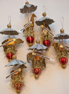 twelve christmas ornaments are arranged on a white surface with gold and red decorations hanging from them