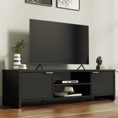 a flat screen tv sitting on top of a black entertainment center