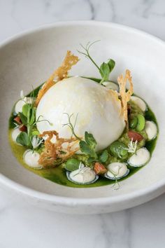 a white bowl filled with food on top of a table