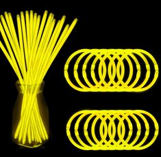 neon yellow glow sticks in a glass vase on a black background, with the top lit up