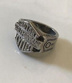 a silver signet ring with words on it