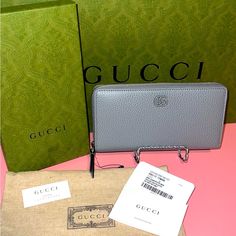 Brand New With Box And Dustbag. The Black Plastic Tag Holder Is On The Zipper. But The Tag Was On The Inside Of The Wallet. Plastic Got Bent In Storage Inside The Box. This Is Grey Soft Leather Inside And Outside And The Gg Is Grey Plastic. Reasonable Offers Will Be Considered. Thanks Designer Evening Wallets With Logo Plaque, Everyday Wallets With Logo Plaque, Elegant Gucci Wallet For Formal Occasions, Elegant Gucci Bifold Bag, Designer Gucci Evening Wallets, Gucci Evening Wallets, Gucci Rectangular Evening Wallets, Evening Gucci Rectangular Wallet, Gucci Evening Wallets Rectangular