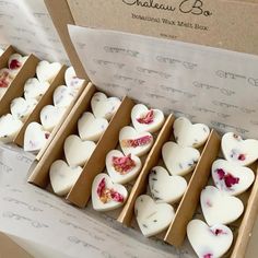 some heart shaped candles are in a box