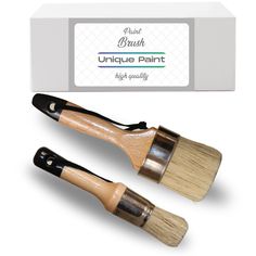 two paint brushes sitting next to each other in front of a box with the words unique paint on it