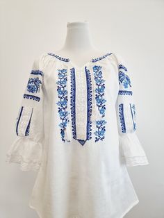 Explore the rich Romanian cultural heritage with our traditional hand-embroidered blouse, featuring a dazzling shade of red. This authentic piece highlights intricate floral designs painstakingly crafted by talented artisans, reflecting the centuries-old tradition of Romanian embroidery. Woven with a blend of history and elegance, our Romanian blouse is a wearable masterpiece. The vibrant shade of blue symbolizes the depth of Romanian traditions, while the hand-embroidered floral designs tell ta Romanian Embroidery, Romanian Blouse, Piece Highlights, Shade Of Red, Folk Costume, Love And Respect, Embroidered Blouse, Shades Of Red, Floral Designs