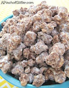 a blue bowl filled with dog treats on top of a yellow and white table cloth