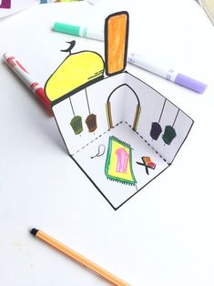 this is an image of a paper cut out with crayons on the table