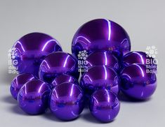 several shiny purple balls are stacked on top of each other with the words big shiny balls above them