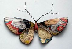 a colorful butterfly is hanging on the wall with string attached to it's wings