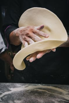 a close up of a person holding a dough dish