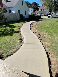 a concrete walkway in front of a house