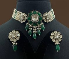 Emerald Polki Green Kundan Victorian Polki set by Sabyasachi showcases antique Indian artistry. The choker features vibrant emerald-green Kundan stones, sparkling Polki diamonds, and Moissanite accents, creating a stunning statement piece. Perfect for adding a touch of regal elegance to any special occasion. *𝐏𝐑𝐎𝐃𝐔𝐂𝐓 𝐃𝐄𝐓𝐀𝐈𝐋* * Material: Brass * Plating: Gold Plated * Stone: Semi Precious Kundan & Polki. *𝐃𝐈𝐒𝐂𝐋𝐀𝐈𝐌𝐄𝐑* Product color may slightly vary due to photographic light Antique Kundan Necklace For Wedding With Tilla, Antique Kundan Bridal Necklace For Wedding, Antique Kundan Necklace For Wedding And Festive Occasions, Vintage Kundan Necklace For Wedding And Festive Occasions, Traditional Festive Choker For Formal Occasions, Antique Bridal Necklace For Wedding And Festivals, Traditional Festive Formal Choker, Formal Traditional Choker, Formal Festive Traditional Choker