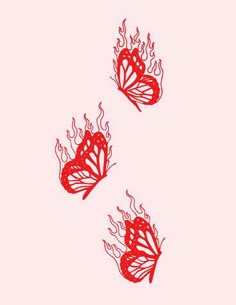 two red butterflies flying in the air with flames coming out of it's wings