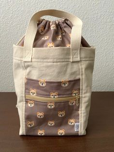 a small bag with an animal print on it sitting on top of a wooden table