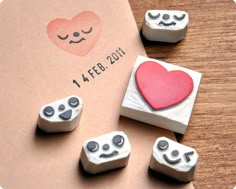 four nintendo wii game controllers with a heart on the front and two hearts on the back