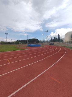 an empty running track on a cloudy day