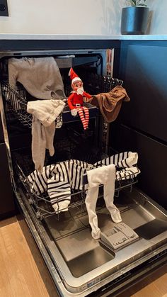 the elf is sitting in the dishwasher