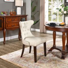 a dining room table with chairs and a rug on the floor in front of it