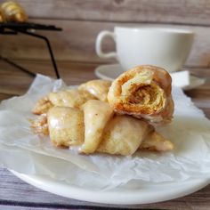 some food on a white plate next to a cup and saucer