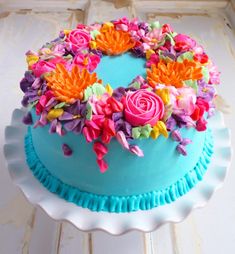 there is a blue cake with flowers on it