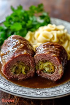 a plate with some meat and pasta on it