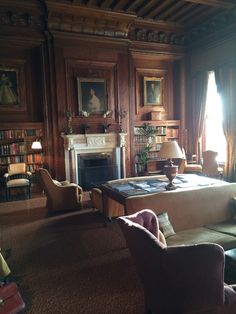 a living room filled with lots of furniture and a fire place next to a fireplace