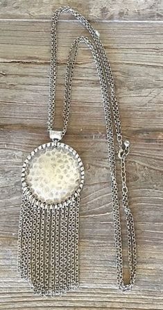 This lovely Silver metal Necklace has a large fringed rondel which hangs from a pretty double chain. The Necklace is 60cm long and the dia of the rondel is 8cm. The necklace weighs 70 grms. This is a vintage, costume jewellery item. Postage from France included. Long Metal Tassel Necklace With Chain, Metal Long Tassel Necklace, Metal Long Dangle Necklace With Chain, Long Metal Tassel Necklace, Silver Metal Tassel Necklace, Silver Metal Tassel Necklace With Adjustable Chain, Silver Tassel Necklace With Adjustable Chain, Silver Long Tassel Necklace, Vintage Long Silver Chain Necklace