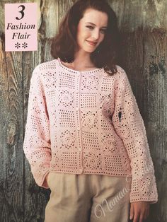 a woman wearing a pink sweater and tan pants in front of a wooden wall with the words fashion flair written on it