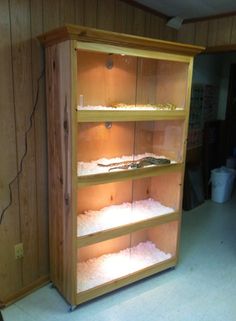 an empty shelf in the corner of a room filled with shelves full of items and other things