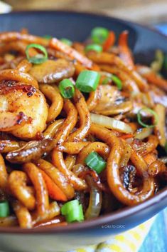 a bowl filled with shrimp and vegetables on top of a table