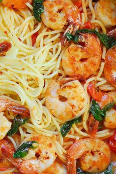 pasta with shrimp, spinach and tomato sauce in a pan ready to be cooked