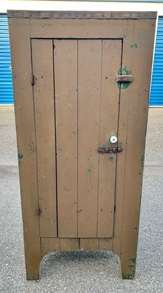 an old wooden cabinet sitting on top of a sidewalk