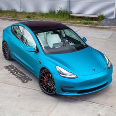 a blue sports car parked in a parking lot