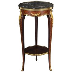 an ornate wooden table with marble top