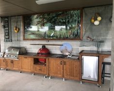 an outdoor kitchen with wood cabinets and appliances