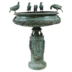 a bronze fountain with birds sitting on it