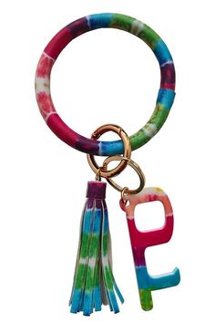 a tie dye keychain with the word peace on it and tassels