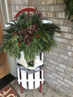 a chair with a christmas wreath on it sitting in front of a door