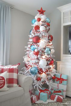 a christmas tree decorated with red, white and blue ornaments