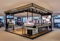 the inside of a jewelry store with lots of products on display in front of large windows