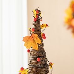 a tree made out of twigs with leaves and berries