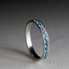 a wedding ring with blue stones on it