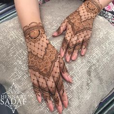 two hands with hendi designs on them