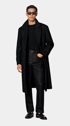 Tailored to a knee length, this black overcoat features a wide peak lapel and natural shoulders. With its double-breasted closure, inside pockets, and a martingale belt, it ensures both style and practicality. Timeless Gabardine Outerwear For Fall, Timeless Double-breasted Outerwear For Fall, Single Breasted Gabardine Outerwear For Winter, Winter Single Breasted Gabardine Outerwear, Single-breasted Gabardine Outerwear For Winter, Winter Single-breasted Gabardine Outerwear, Luxury Long Coat For Fall, Timeless Long Sleeve Gabardine Outerwear, Fall Gabardine Wool Coat With Long Sleeves