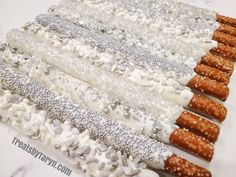 there are many different types of bracelets on the table with white and silver beads