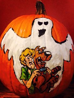 a pumpkin decorated with an image of two dogs and a ghost