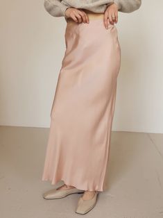 Light pink 90's inspired bias cupro maxi skirt with side zipper closure. Style with your favorite sweaters and ballet flats. CONTENT + CARE 60% Cupro | 40% Viscose SIZE + FIT Model is wearing a size small. S (2-4), M (6-8), L (10-12) Spring Bias Cut Skirt, Chic Solid Color Ankle-length Skirt, Chic Ankle-length Skirt, Spring Bias Cut Relaxed Maxi Skirt, Spring Relaxed Bias Cut Maxi Skirt, Fitted Bias Cut Maxi Skirt For Summer, Spring Relaxed Fit Bias Cut Maxi Skirt, Spring Satin Maxi Skirt, Spring Flowy Bias Cut Skirt