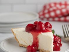 a slice of cheesecake with cherries on top