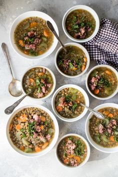 several bowls of soup are arranged on a table