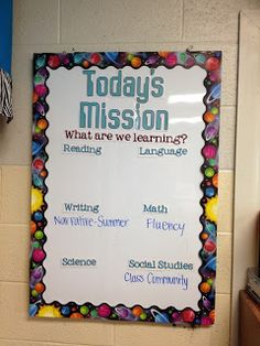 a bulletin board hanging on the wall in a classroom with information about what are we learning